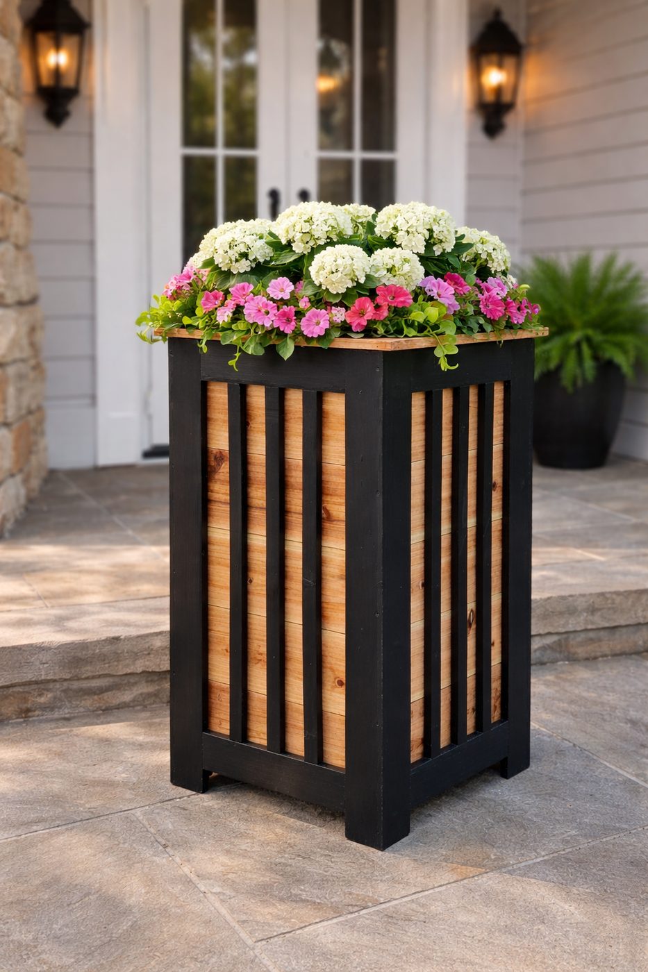 Camden Collection architectural planter with blackened frame and cedar slats, filled with flowers